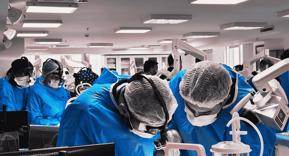 Surgical professionals engaged in a hands-on cadaver workshop during an ARCAS Education postgraduate training program.