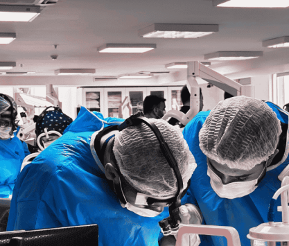 Surgical professionals engaged in a hands-on cadaver workshop during an ARCAS Education postgraduate training program.